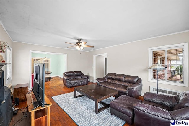 600 Greenway Dr, Florence, SC 29501 - living room with ceiling fan with notable chandelier, hardwood / wood-style floors, radiator heating unit, and crown molding