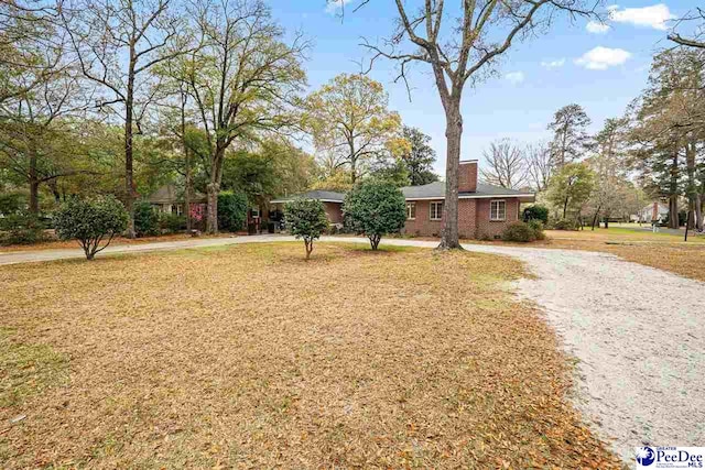 600 Greenway Dr, Florence, SC 29501 - single story home featuring brick siding, driveway, a chimney, and a front yard