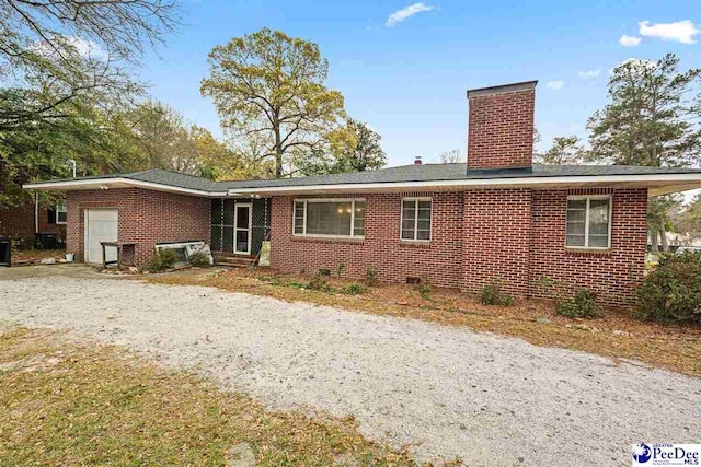 600 Greenway Dr, Florence, SC 29501 - back of house featuring a garage, brick siding, and a chimney