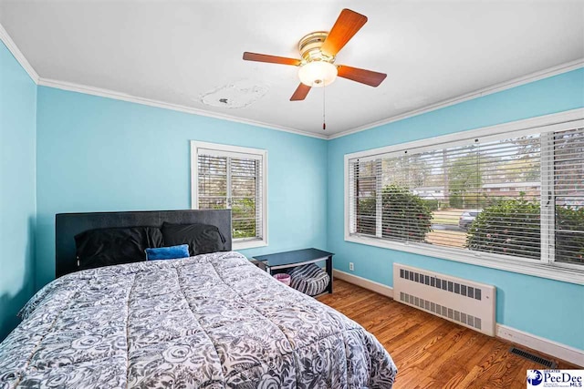 600 Greenway Dr, Florence, SC 29501 - bedroom featuring radiator, wood finished floors, baseboards, visible vents, and ornamental molding