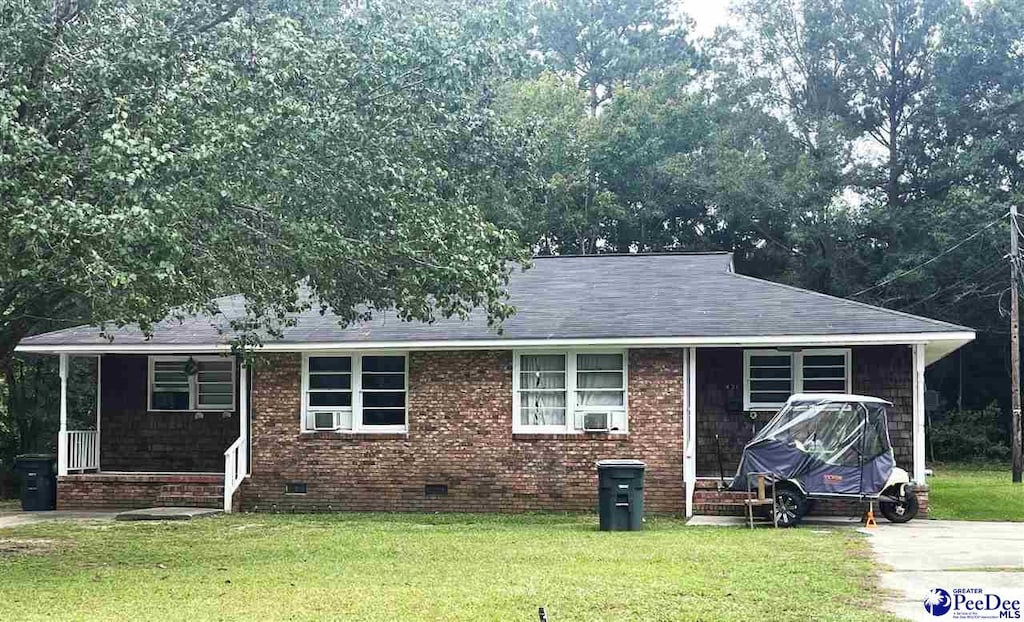 view of front of property with cooling unit and a front lawn