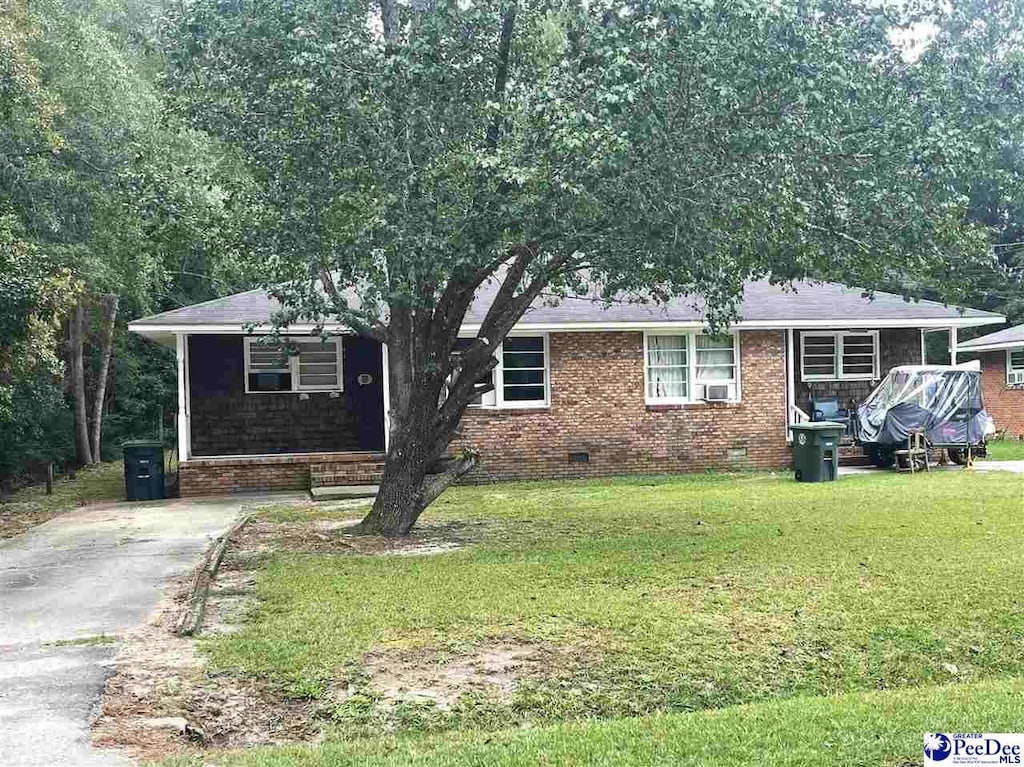 view of front of property featuring cooling unit and a front lawn