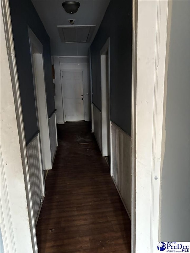 hallway with attic access and dark wood-style flooring