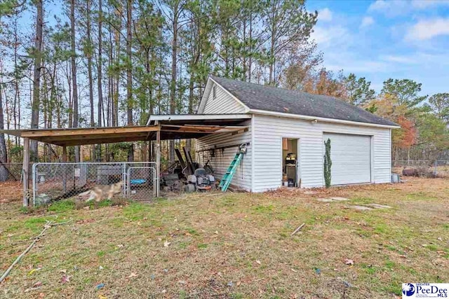 exterior space with a garage, a lawn, and a carport