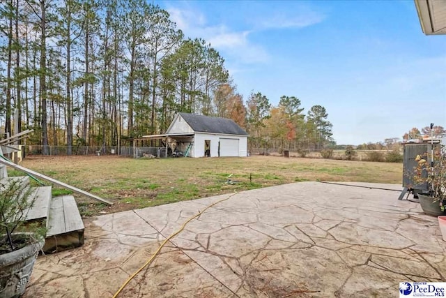 view of patio featuring a garage and an outdoor structure