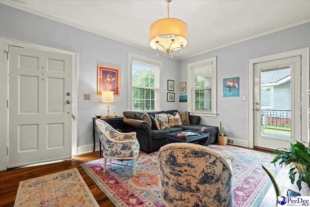 318 Mcleod St, Florence, SC 29501 - living room featuring dark wood-style flooring, crown molding, and a chandelier