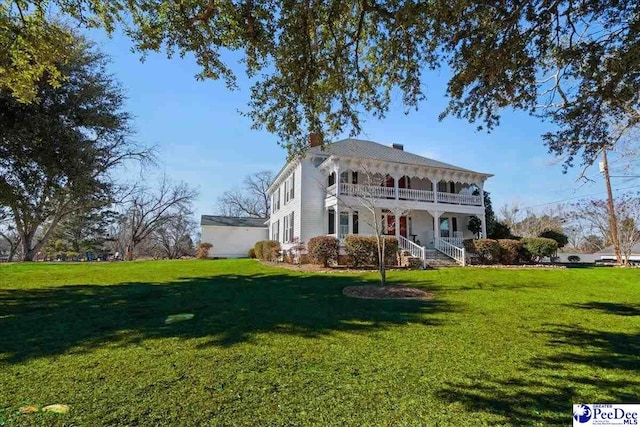 italianate-style house with a front yard and a chimney