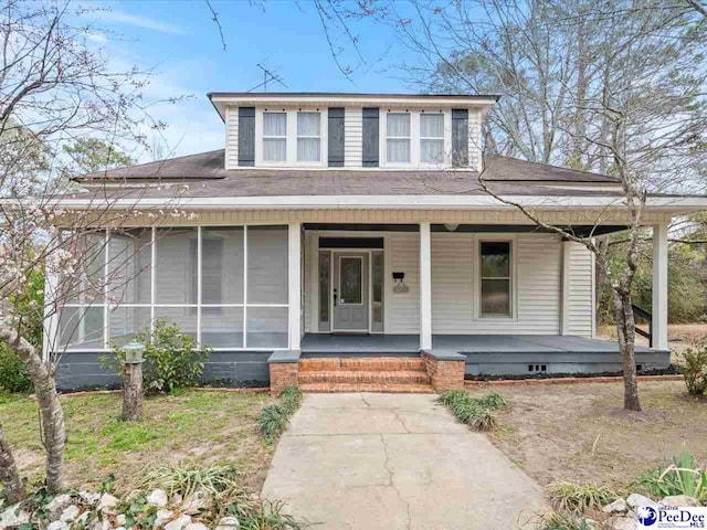 view of front of property with a porch and roof with shingles