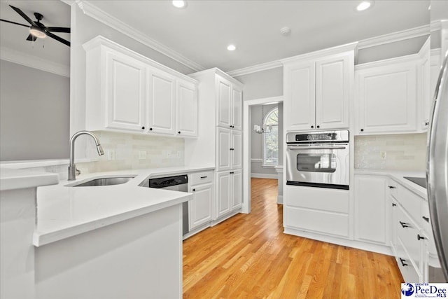 716 Lindsey Dr, Florence, SC 29501 - kitchen with stainless steel appliances, a sink, recessed lighting, crown molding, and white cabinetry