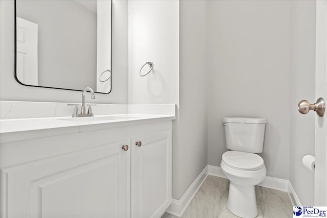 716 Lindsey Dr, Florence, SC 29501 - half bathroom with baseboards, toilet, and vanity