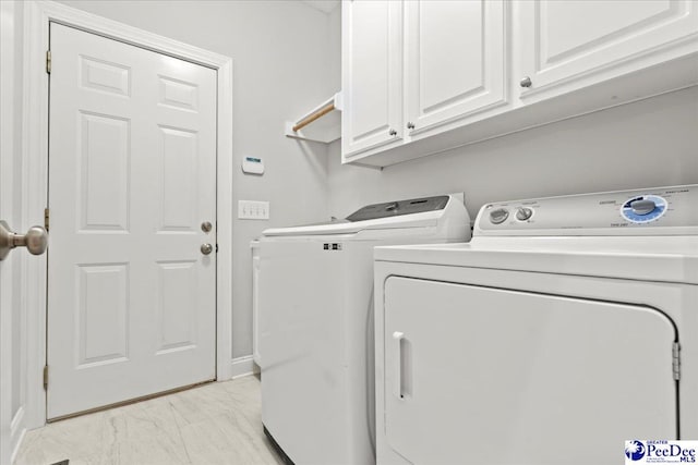 716 Lindsey Dr, Florence, SC 29501 - laundry room featuring washing machine and dryer, cabinet space, light marble finish flooring, and baseboards