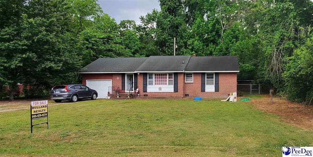 1212 Tator House Rd, Bennettsville, SC 29512 - ranch-style house with a garage, brick siding, a front lawn, crawl space, and a wooded view