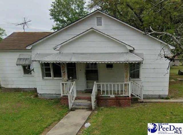 bungalow with a porch and a front yard