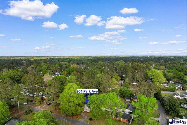 birds eye view of property featuring a forest view