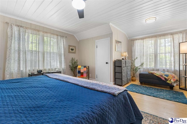bedroom featuring ceiling fan, ornamental molding, and wood finished floors