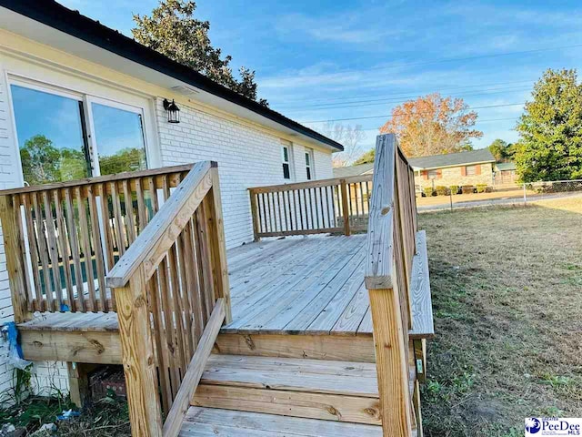 wooden deck featuring a yard