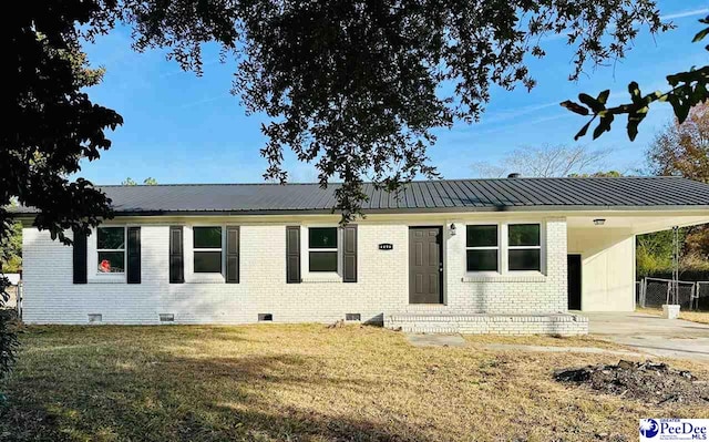 single story home featuring a carport and a front yard