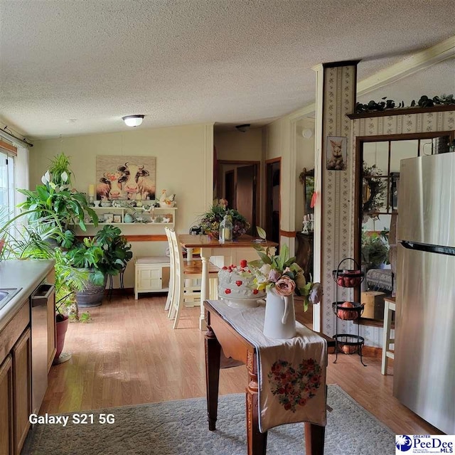 2378 Nichols Ln 2374, 2376, Effingham, SC 29541 - dining room featuring a textured ceiling, lofted ceiling, and light wood-style floors