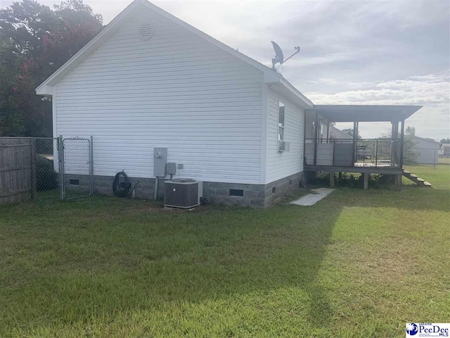 view of property exterior with central AC unit and a lawn