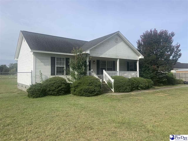 ranch-style home with a porch and a front lawn