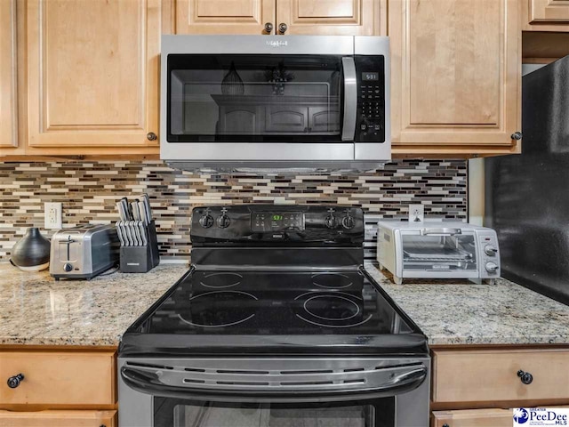 kitchen featuring backsplash, appliances with stainless steel finishes, light stone countertops, and light brown cabinets