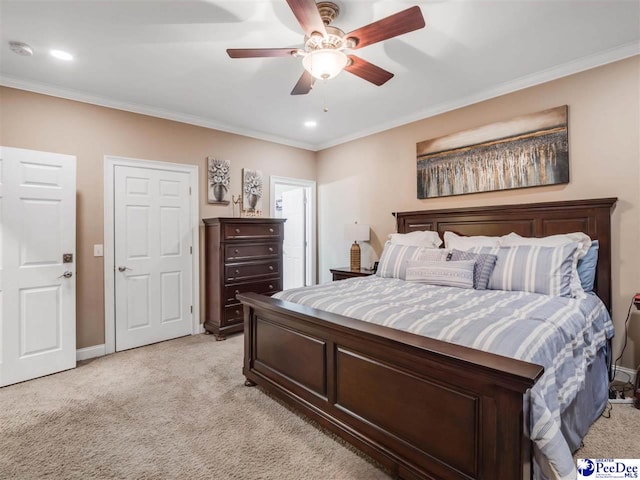 carpeted bedroom with ornamental molding and ceiling fan