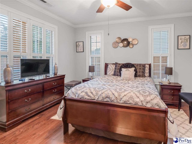 bedroom featuring crown molding, ceiling fan, and light hardwood / wood-style floors