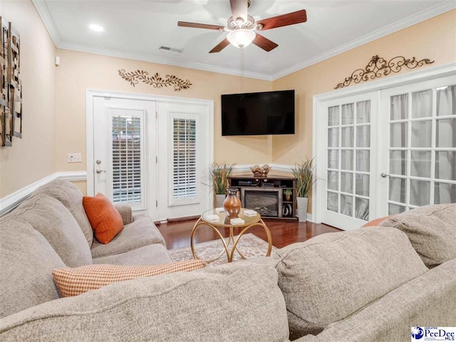 living room featuring dark hardwood / wood-style flooring, ornamental molding, french doors, and ceiling fan