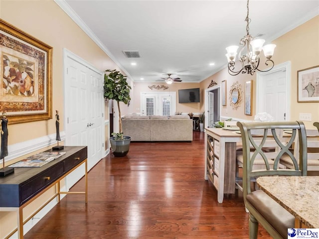 interior space featuring crown molding, dark hardwood / wood-style flooring, and an inviting chandelier