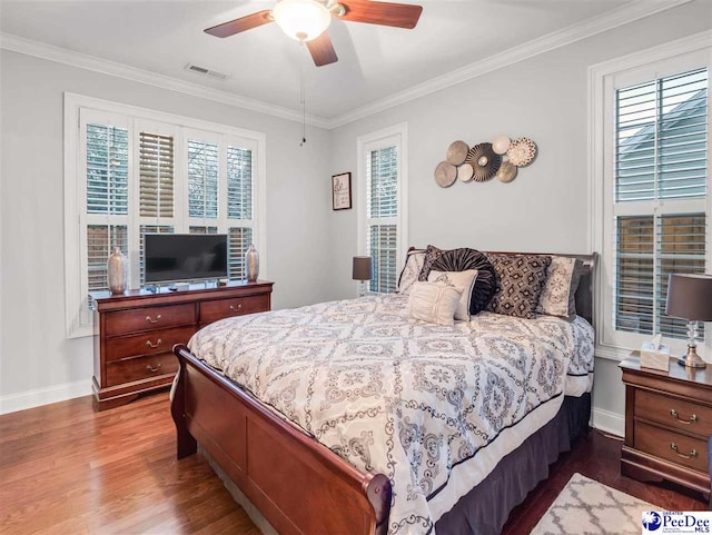 bedroom featuring crown molding, wood-type flooring, and ceiling fan