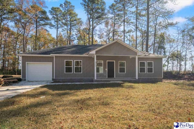 ranch-style house featuring a garage, a front yard, and covered porch