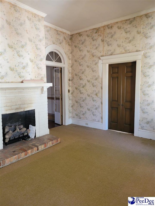 601 Cashua St, Darlington, SC 29532 - unfurnished living room featuring wallpapered walls, carpet, a fireplace, crown molding, and baseboards