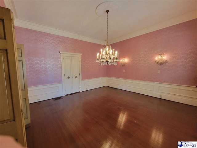 601 Cashua St, Darlington, SC 29532 - unfurnished dining area featuring dark wood-style floors, a chandelier, wainscoting, ornamental molding, and a decorative wall