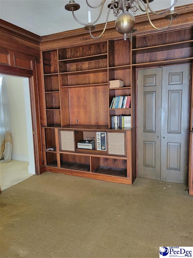 601 Cashua St, Darlington, SC 29532 - unfurnished living room featuring carpet flooring, crown molding, built in shelves, and a chandelier