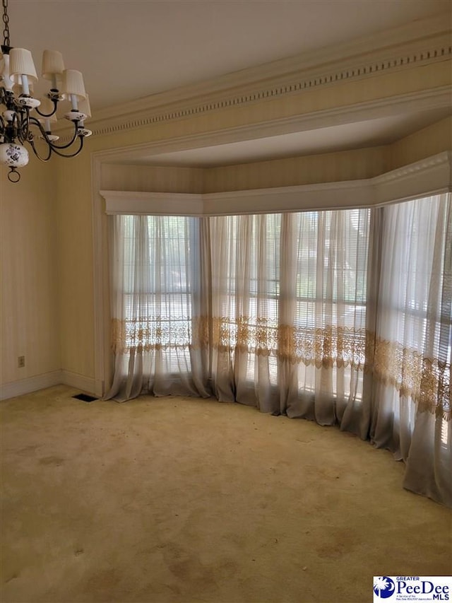 601 Cashua St, Darlington, SC 29532 - carpeted spare room featuring crown molding and a chandelier