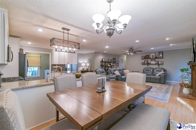 100 Warren Way, Cheraw, SC 29520 - dining area featuring a chandelier, light wood finished floors, a ceiling fan, a textured ceiling, and crown molding