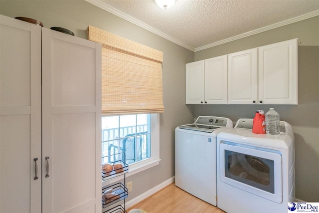 100 Warren Way, Cheraw, SC 29520 - laundry area with cabinet space, washer and clothes dryer, light wood-style floors, a textured ceiling, and ornamental molding