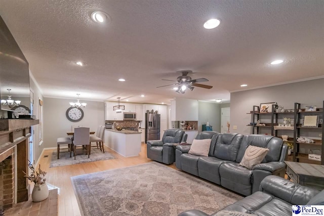 100 Warren Way, Cheraw, SC 29520 - living area with ornamental molding, ceiling fan, light wood-style flooring, a fireplace, and a textured ceiling