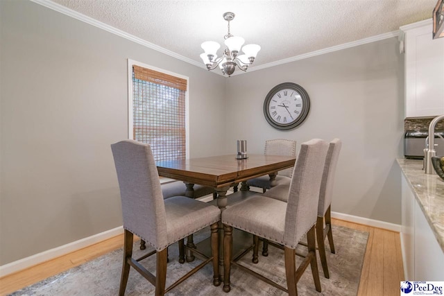 100 Warren Way, Cheraw, SC 29520 - dining area featuring a chandelier, light wood finished floors, ornamental molding, a textured ceiling, and baseboards