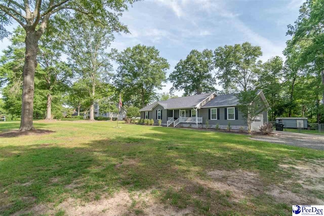 100 Warren Way, Cheraw, SC 29520 - view of front of home with covered porch, a front lawn, driveway, and an attached garage