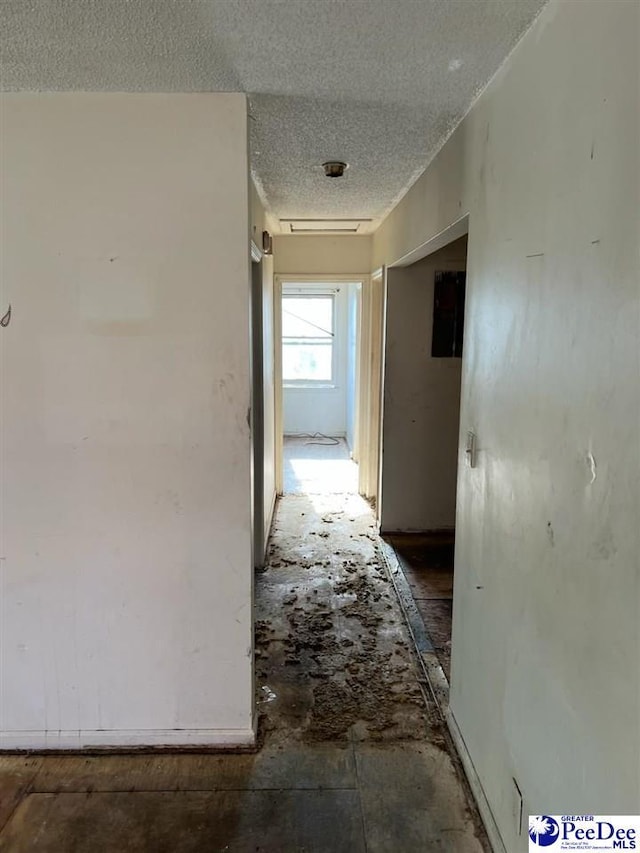 hallway with a textured ceiling