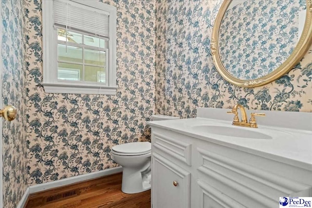 3427 Sussex Ct, Florence, SC 29501 - half bath featuring wallpapered walls, wood finished floors, and vanity