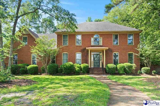 3427 Sussex Ct, Florence, SC 29501 - colonial-style house featuring a front lawn and brick siding