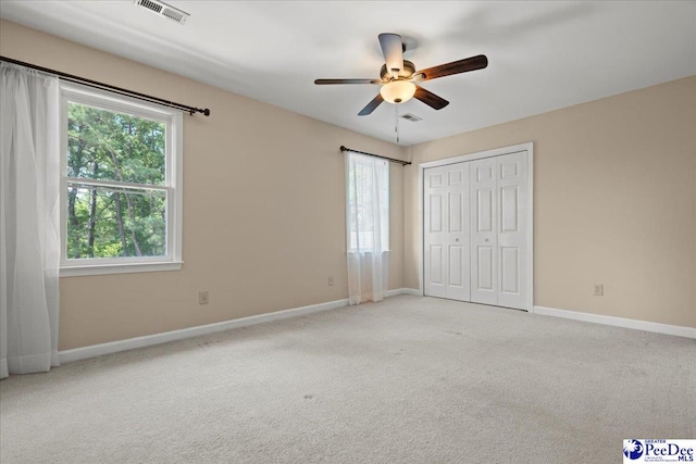 3427 Sussex Ct, Florence, SC 29501 - unfurnished bedroom with multiple windows, carpet, a closet, and ceiling fan