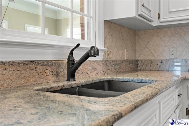 3427 Sussex Ct, Florence, SC 29501 - kitchen featuring white cabinetry, tasteful backsplash, and light stone counters