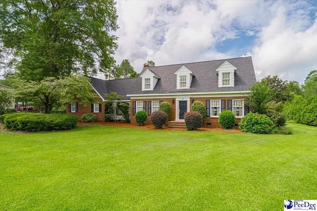 cape cod-style house featuring a front yard