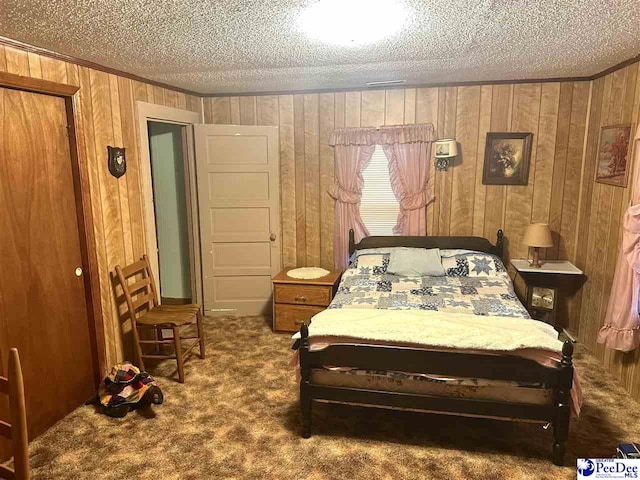 carpeted bedroom featuring crown molding, a textured ceiling, and wood walls