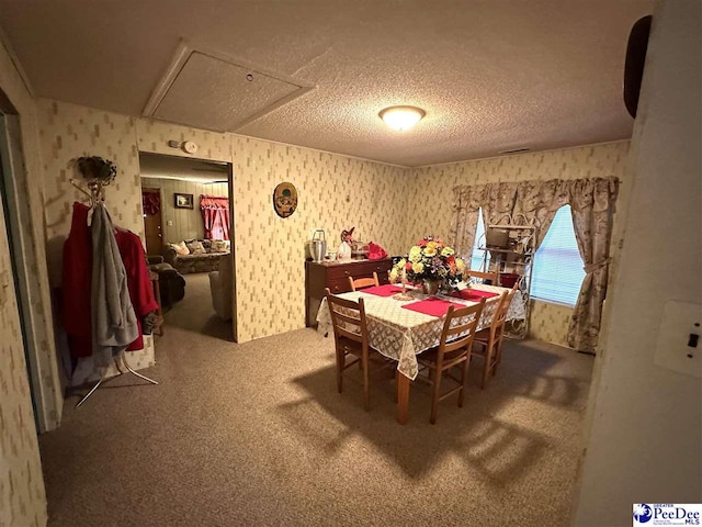 dining room featuring carpet flooring and a textured ceiling