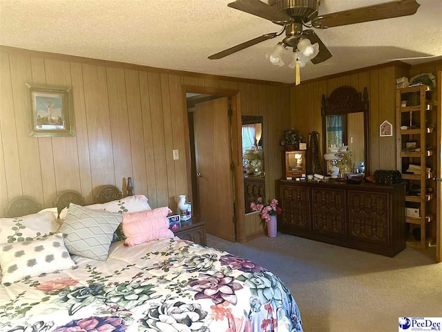 carpeted bedroom with ornamental molding and a textured ceiling