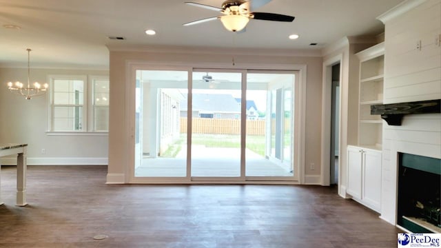 855 Bellemeade Cir, Florence, SC 29501 - unfurnished living room featuring ceiling fan, crown molding, a chandelier, dark wood-style floors, and built in shelves